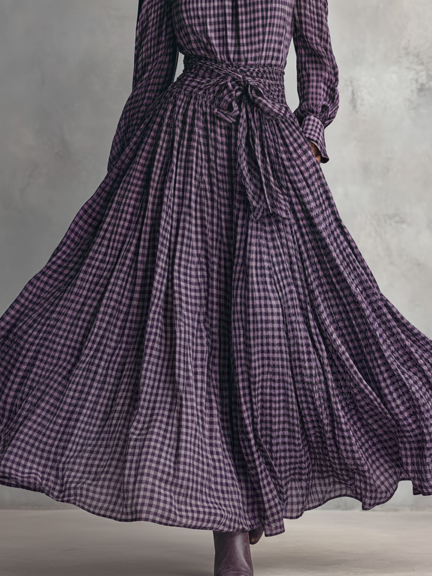 Close-up of the belted waist and pleated skirt flow
