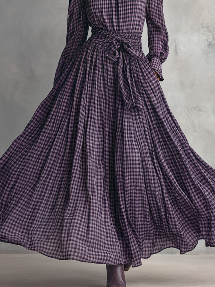 Close-up of the belted waist and pleated skirt flow