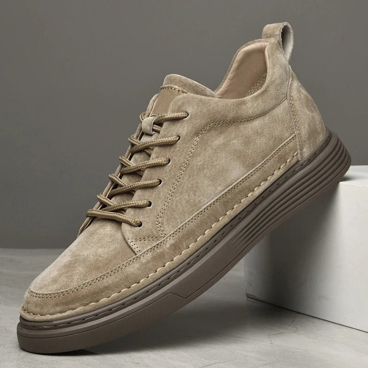 Side profile of khaki men's leather sneaker on display box