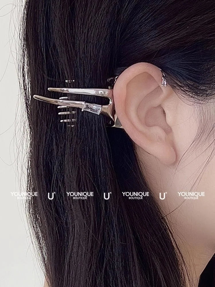 Close-up of woman wearing silver fairy wing ear drop accessory