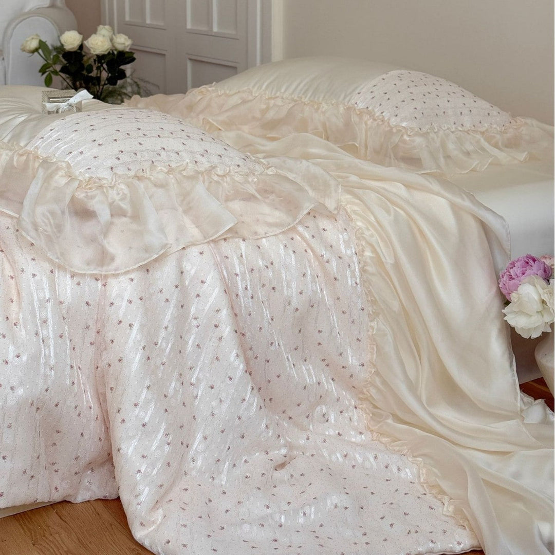 Close-up of the silky soft cocoa whisper bedding set with sheer ruffles