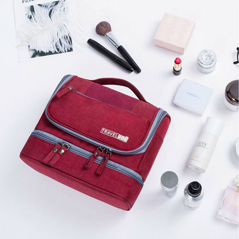 Water-resistant travel toiletry organizer bag zipped up, showing sleek unisex design and durable handle