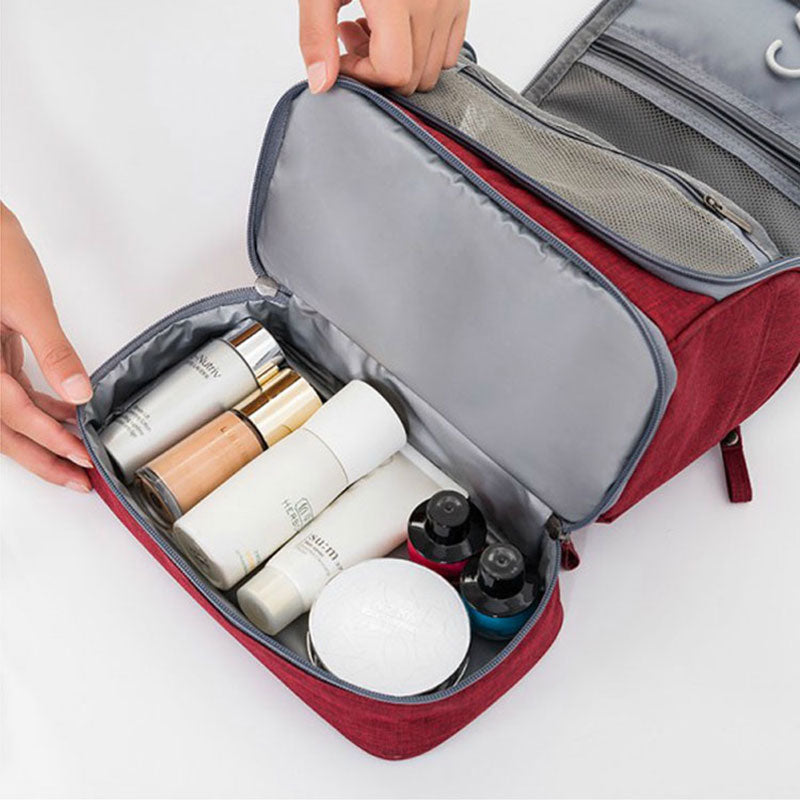 Close-up of internal mesh pockets and elastic straps inside the hanging cosmetic bag for secure storage