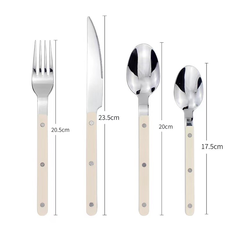 Shiny stainless steel teaspoon capturing natural light on a white surface