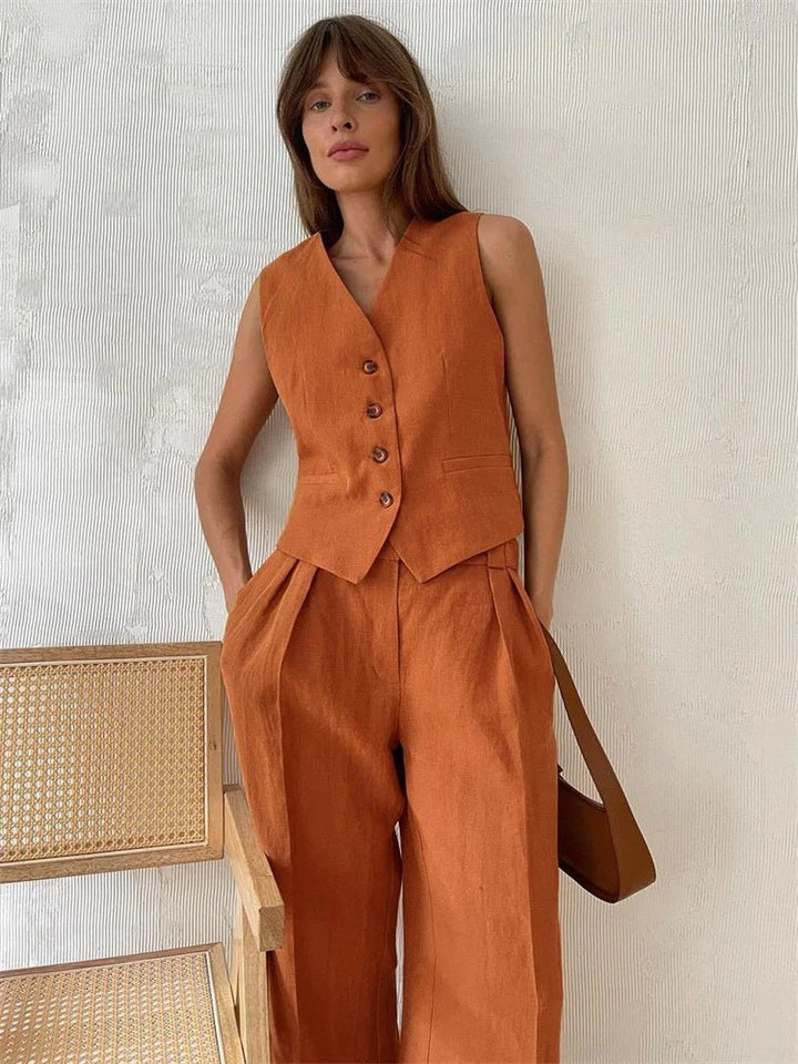 Woman wearing the orange linen vest and pleated wide-leg pants two-piece set