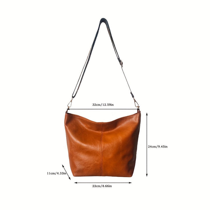 Handheld view emphasizing the generous size of the retro geometric tote
