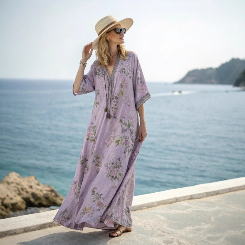 Woman wearing a light purple maxi dress by the sea