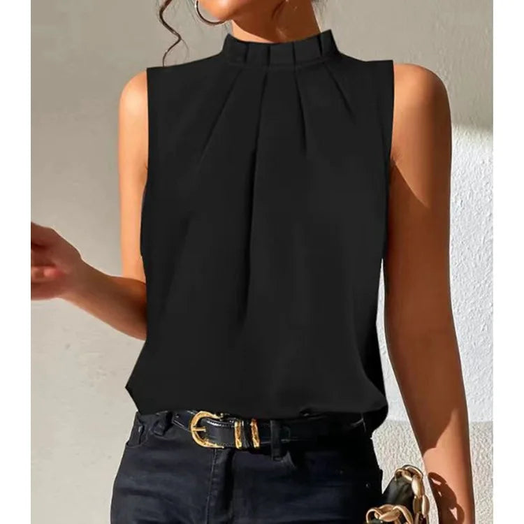 Woman wearing a black sleeveless pleated top with high collar