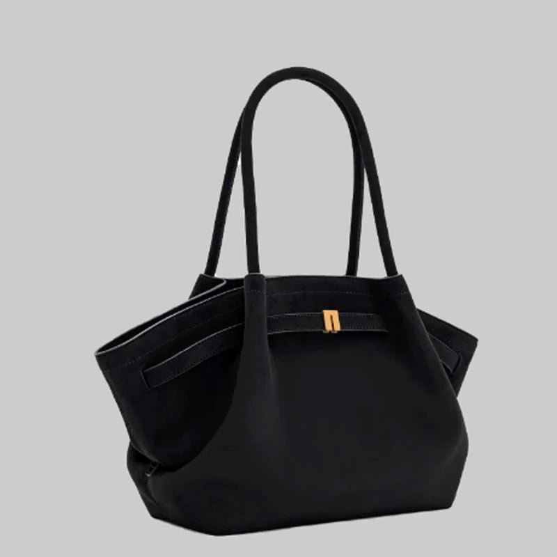 Black women's shoulder bag viewed from an angle showing zipper and strap details
