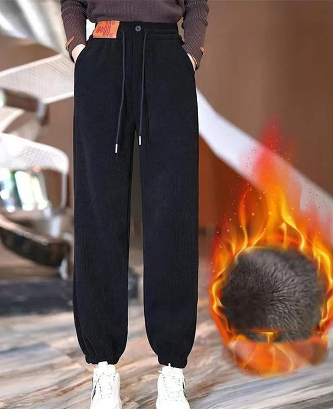 Woman wearing black extra warm winter joggers with white sneakers