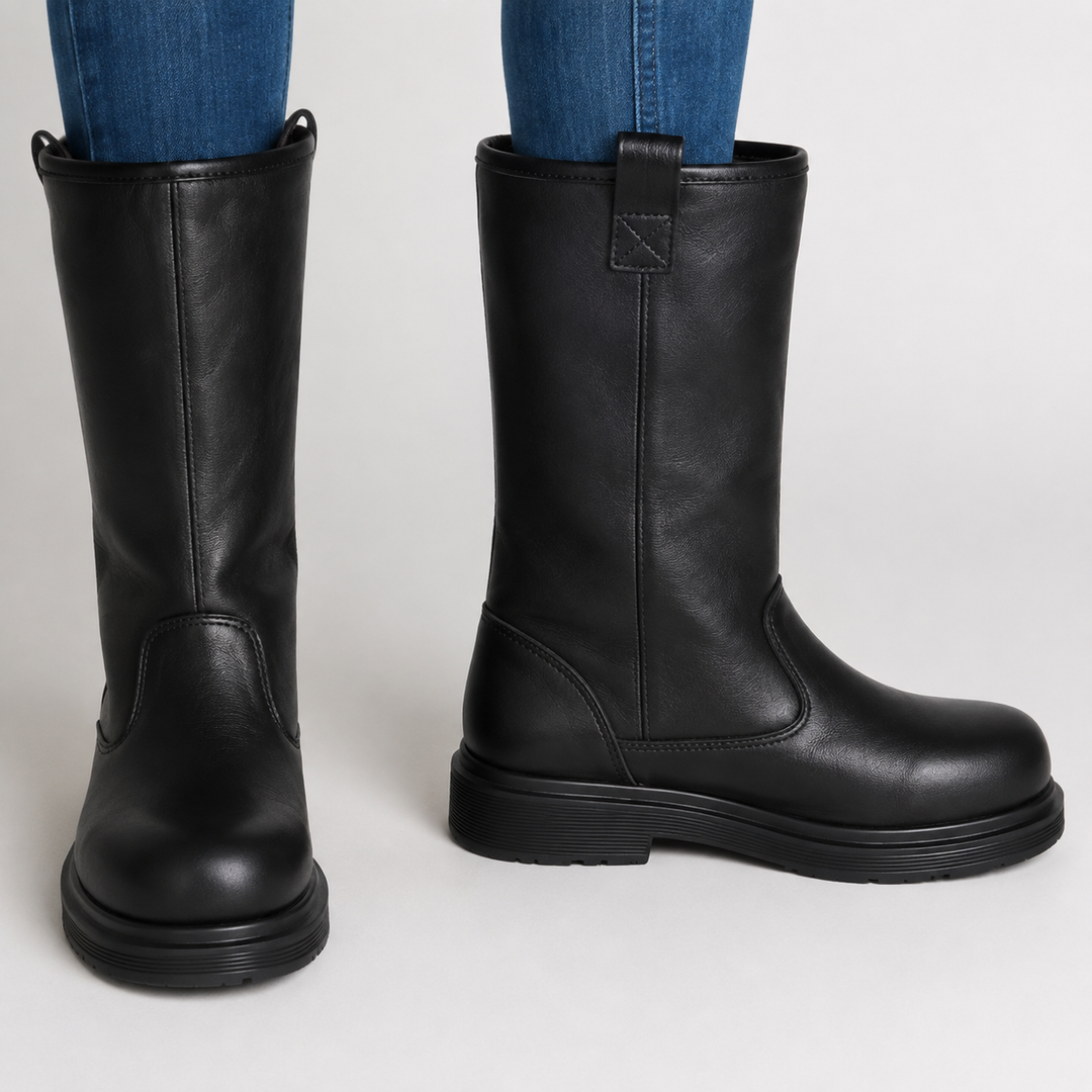 Front view of black mid-calf boots worn with blue jeans