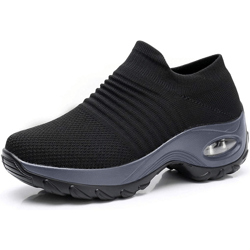 Side profile of black slip-on orthopedic sneaker showcasing cushioned air sole