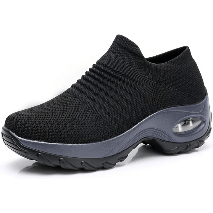 Side profile of black slip-on comfort walking shoe with grey sole