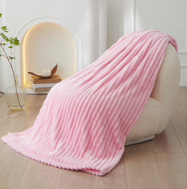 Chunky knit textured throw blanket draped elegantly over a modern living room sofa.