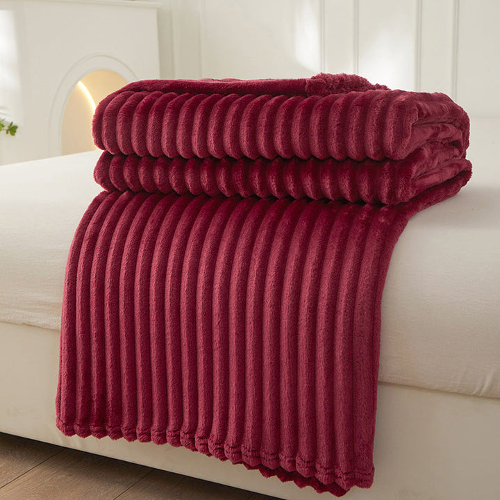 Close up view of the cozy chunky knit fabric and soft texture on a bed throw.