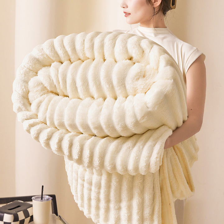 Decorative chunky knit blanket folded neatly on a wooden chair for home decor.