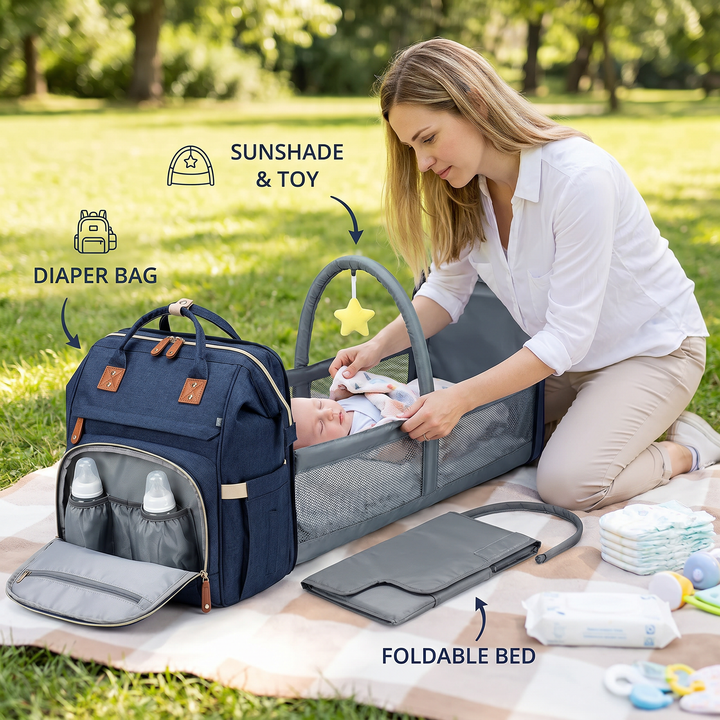 Mother setting up the portable baby bed component of the diaper backpack on a picnic blanket
