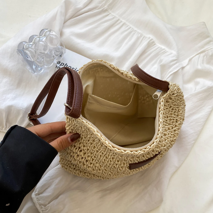 Top view of the open interior compartment and pockets of the beige bag