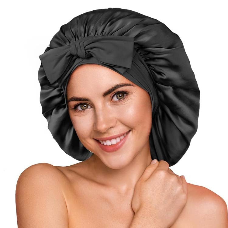 Woman wearing black sleep hair bonnet cap