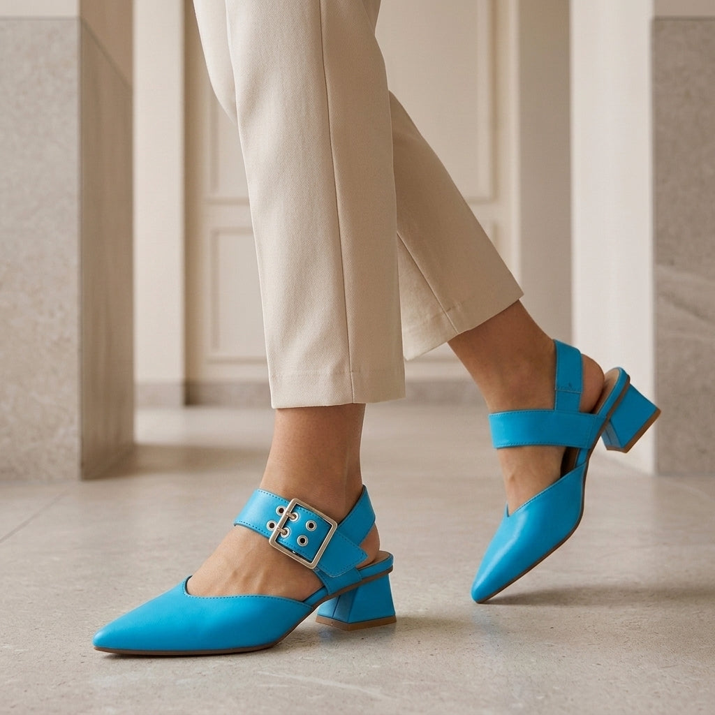 Model wearing blue pointed toe slingback block heels with cropped trousers