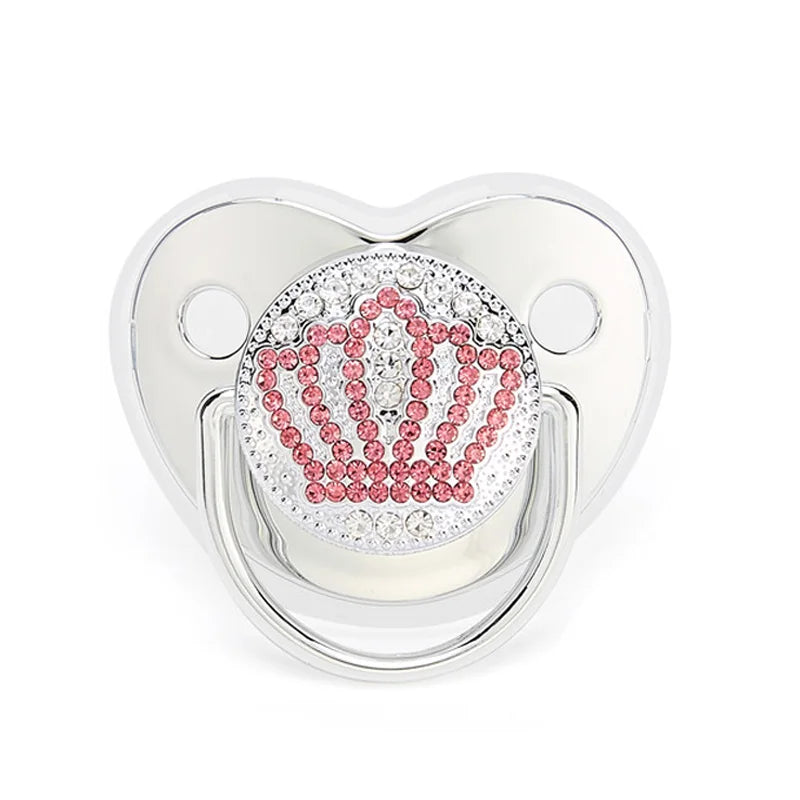 Close-up view of infant silicone soother featuring a royal crown shield