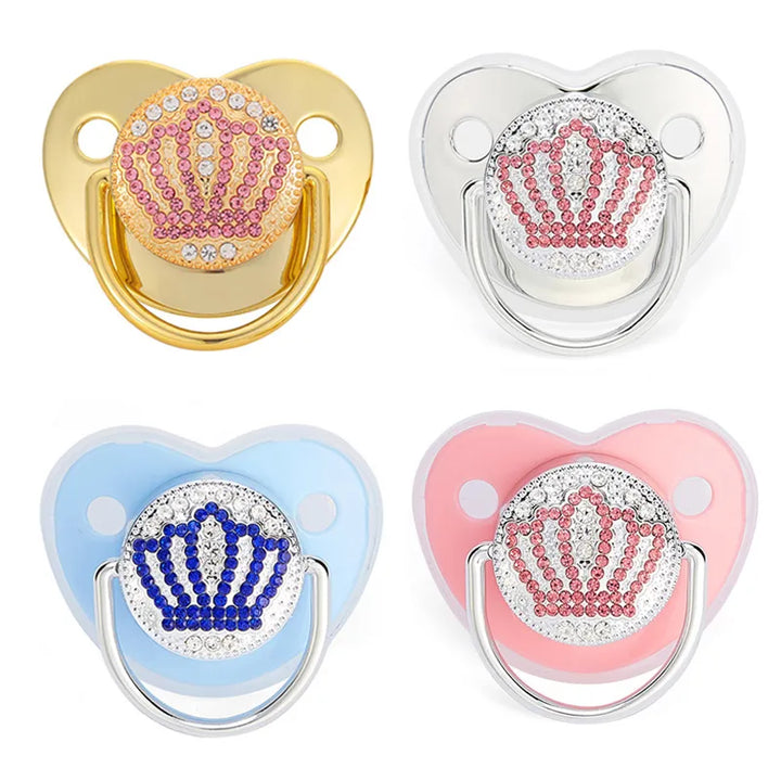 Baby silicone soother and teething aid with decorative crown motif