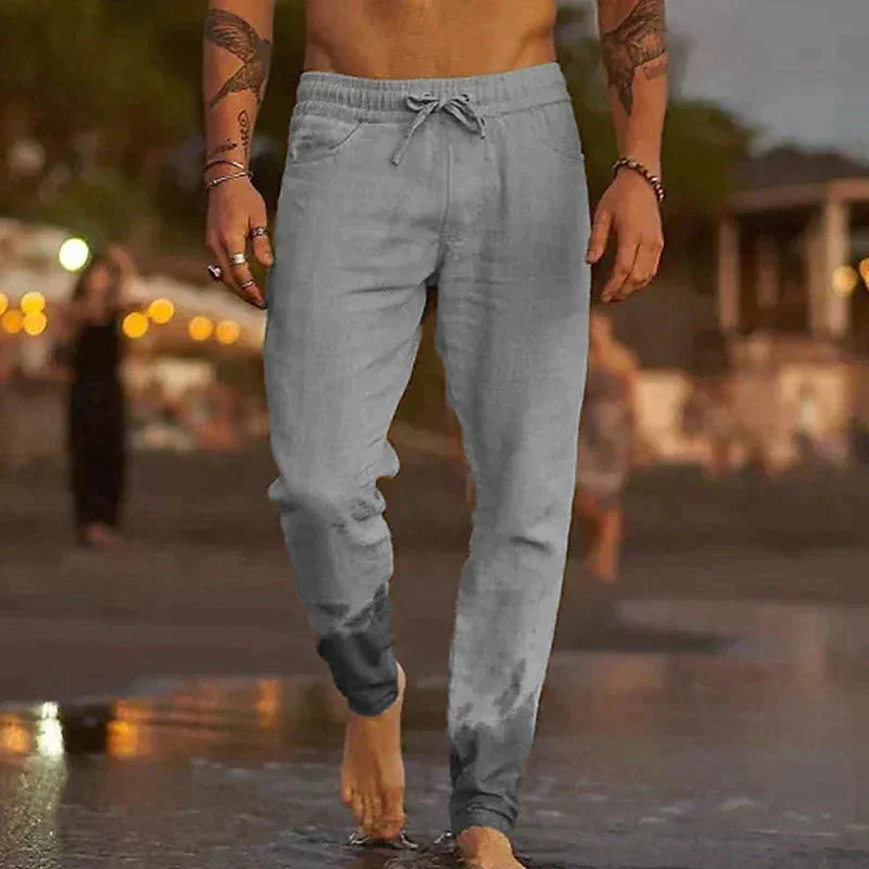 Man wearing grey casual trousers with a relaxed fit