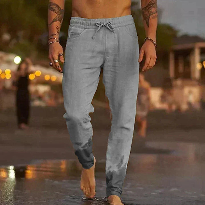 Man wearing grey casual trousers with a relaxed fit