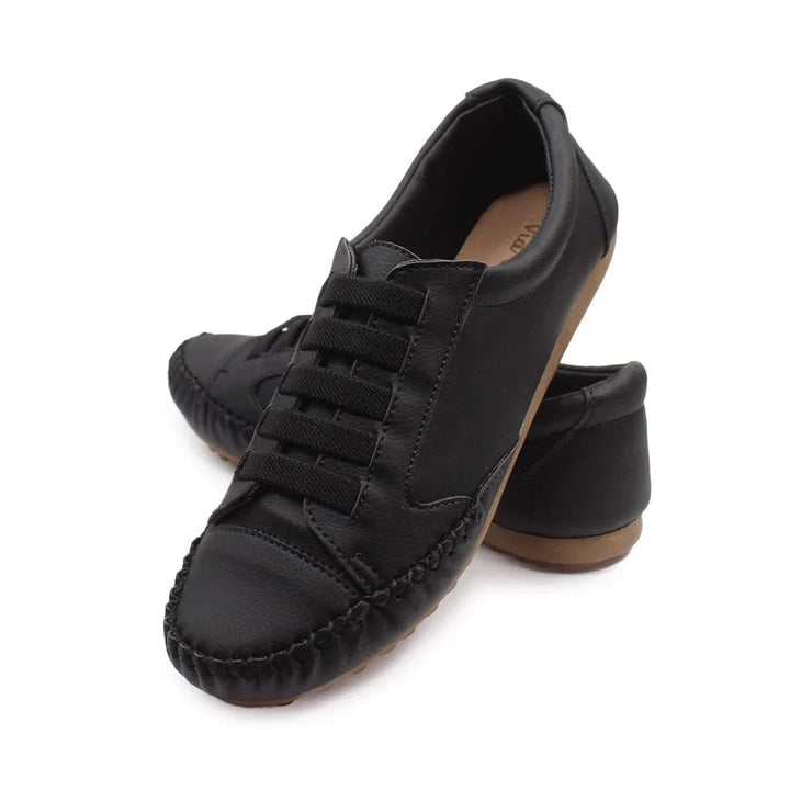 Detailed shot of stitching and premium material on women's trainers