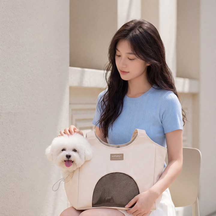 Side view of breathable canvas pet carrier bag showing durable handle and ventilation mesh