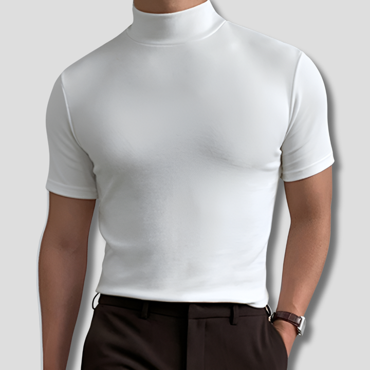 Man wearing white short sleeve turtleneck shirt with dark trousers