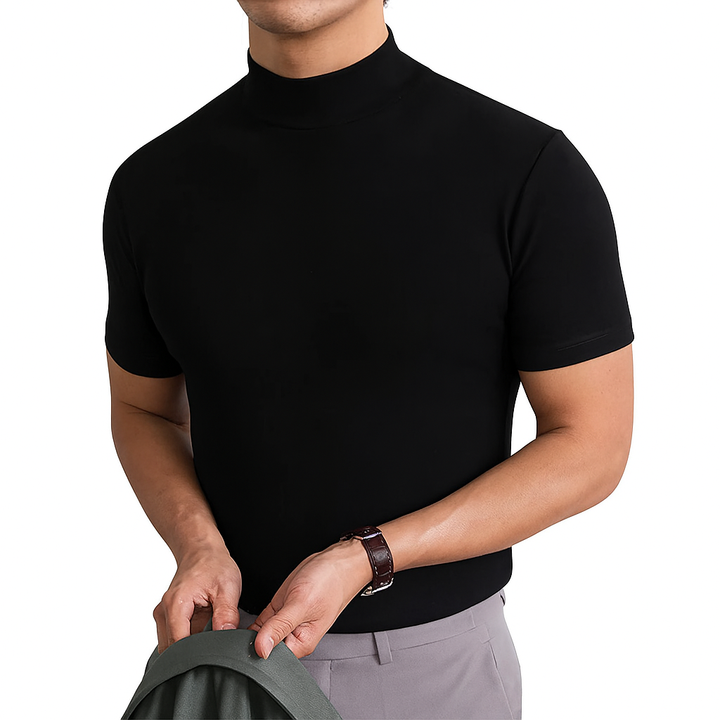 Man wearing black short sleeve turtleneck shirt holding a jacket