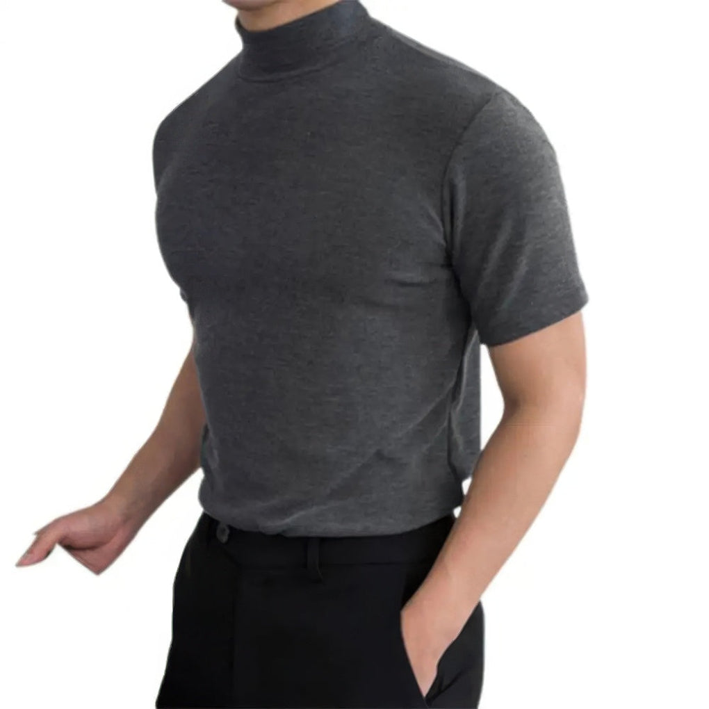 Man wearing dark gray short sleeve turtleneck shirt with black trousers