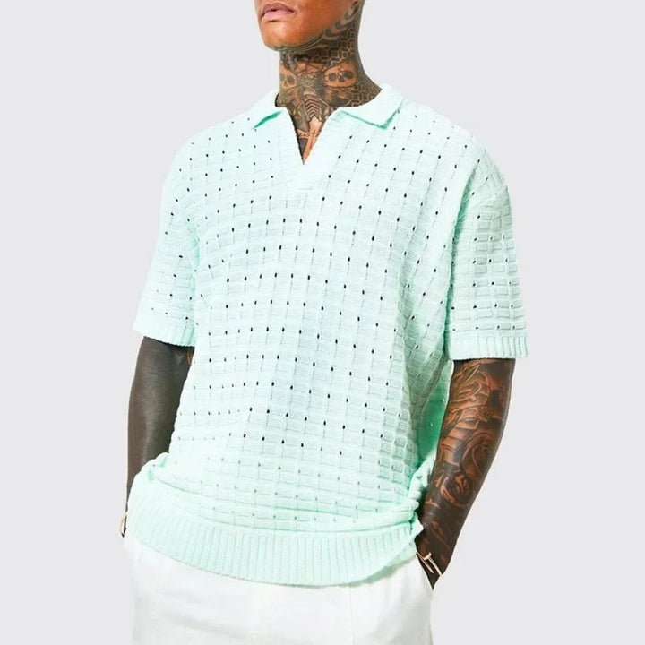 Man wearing light blue oversized knit polo shirt