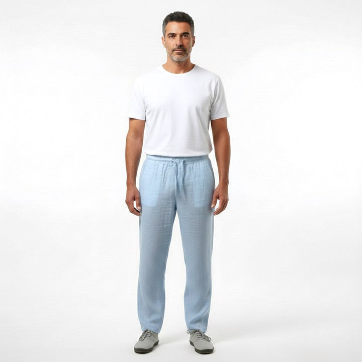 Full length front view of a man wearing light blue casual trousers and a white t-shirt