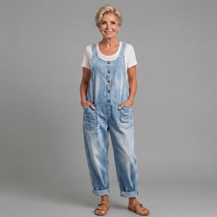 Model wearing light blue relaxed fit denim bib overalls