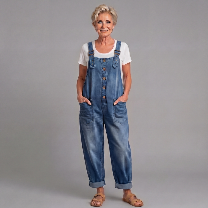 Back view of women's relaxed fit denim bib overalls in classic blue wash