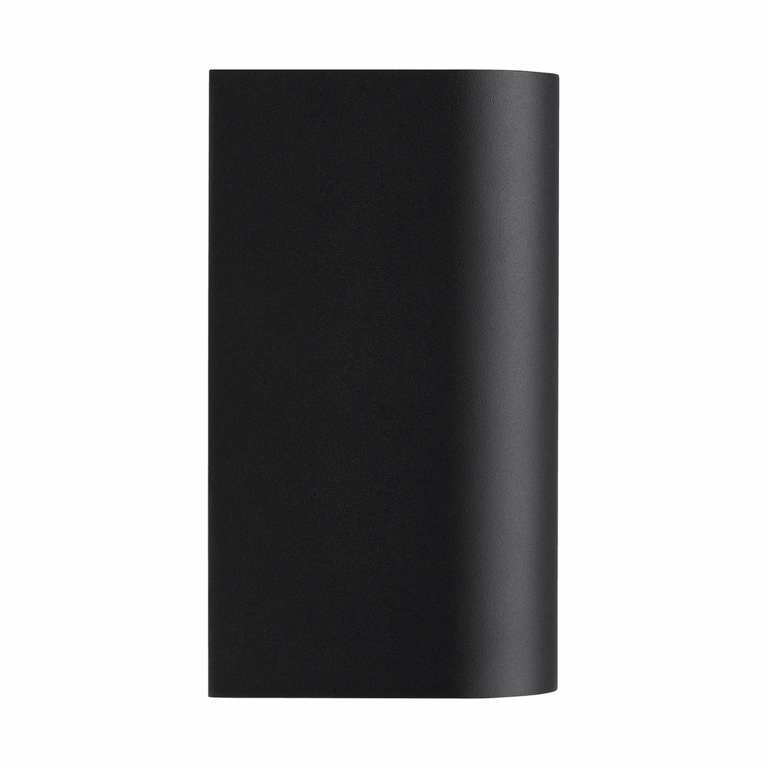 Modern black outdoor wall light glowing on exterior facade