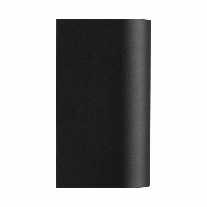 Modern black outdoor wall light glowing on exterior facade