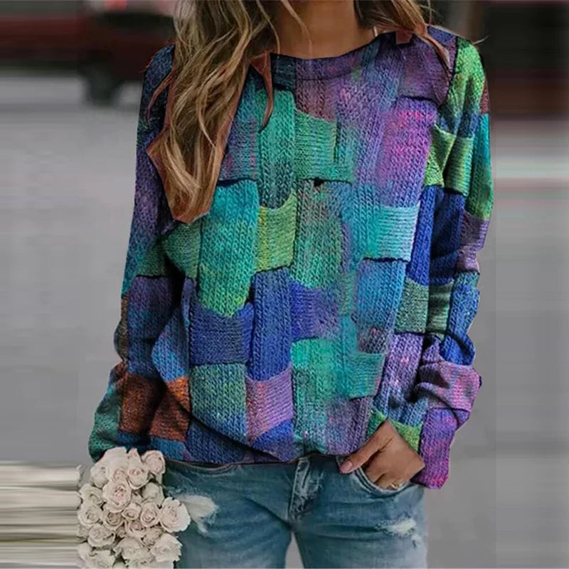 Woman wearing colourful patterned autumn jumper in blue and green tones
