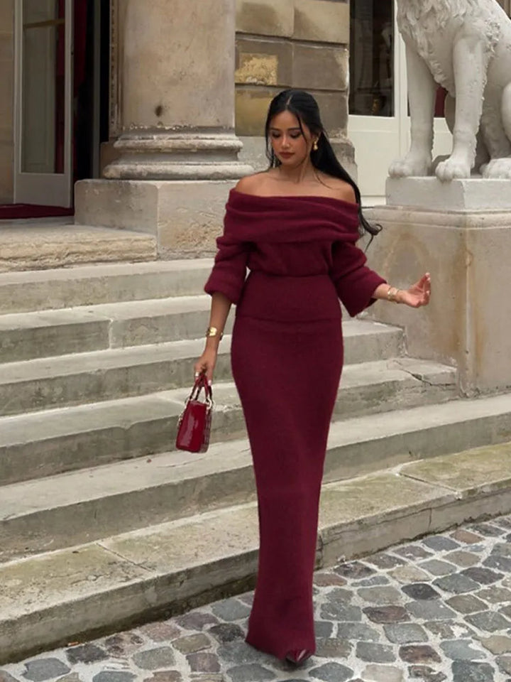 Woman walking outdoors wearing a red off-shoulder pleated maxi dress for evening events
