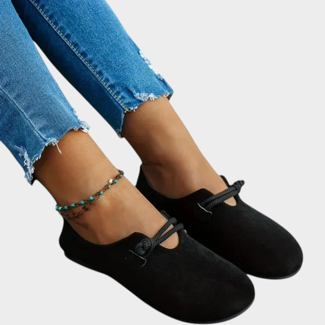 Pair of casual black women's loafers and flat shoes arranged for daily wear
