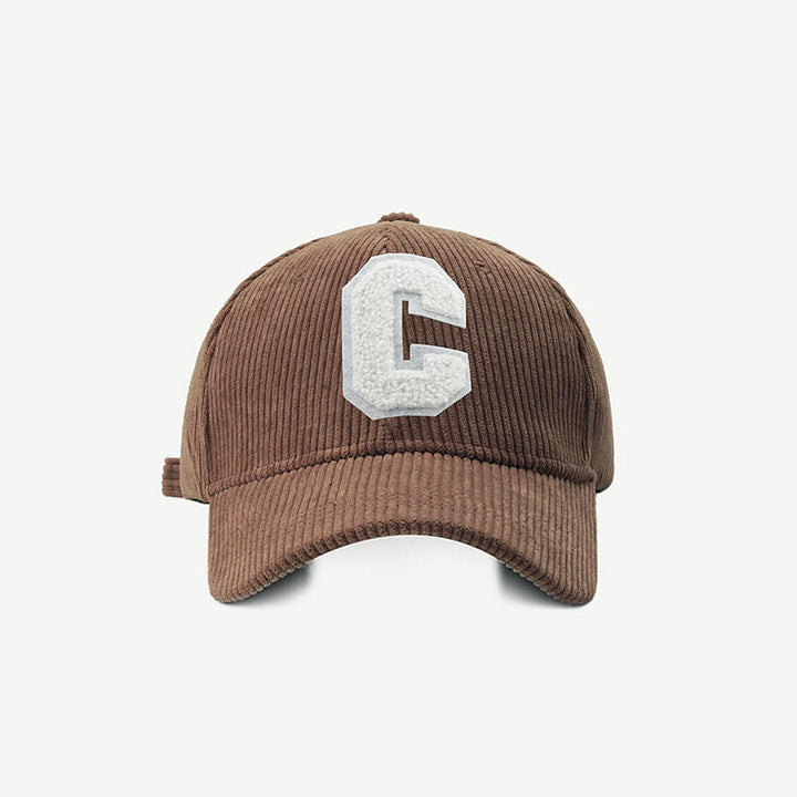 Brown embroidered letter patch cap shown from the front against a plain background