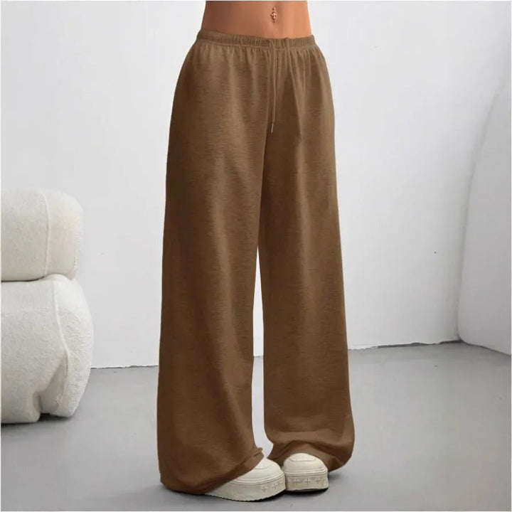 Model wearing Madeline casual wide-leg joggers in dark brown with sneakers