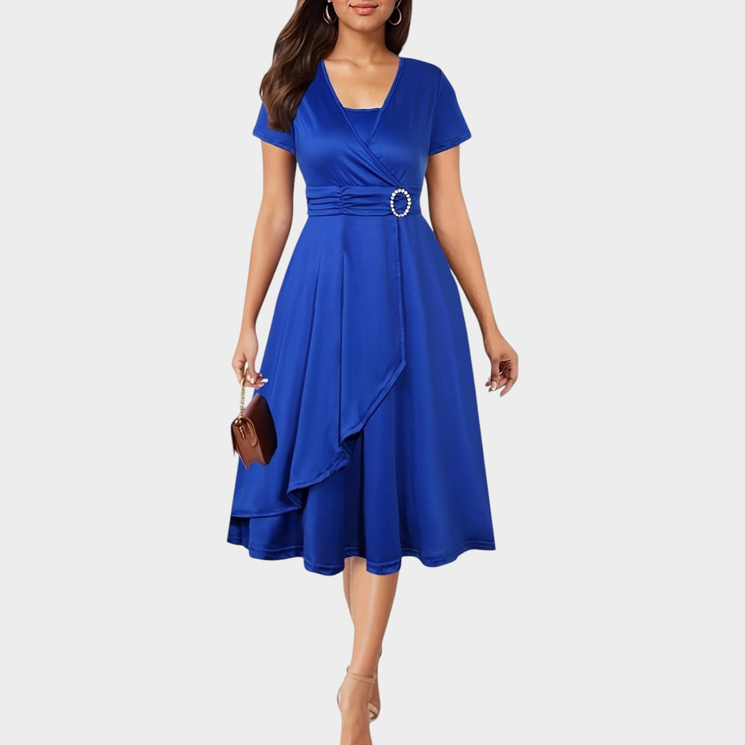 Model wearing blue women's wrap midi dress with rhinestone waist detail and short sleeves