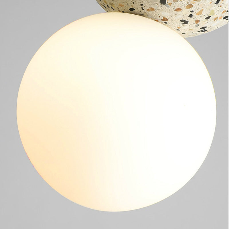Minimalist ceiling light design showing the adjustable suspension cord and mount