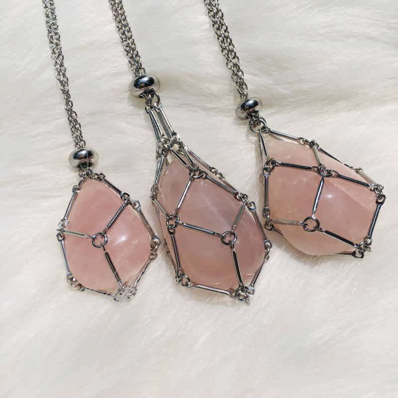 Three natural crystal pendant necklaces displayed side by side on white fabric