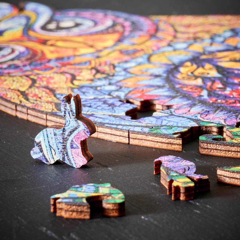 Unisex wooden animal jigsaw puzzle pieces spread out, showcasing unique shapes for creative relaxation