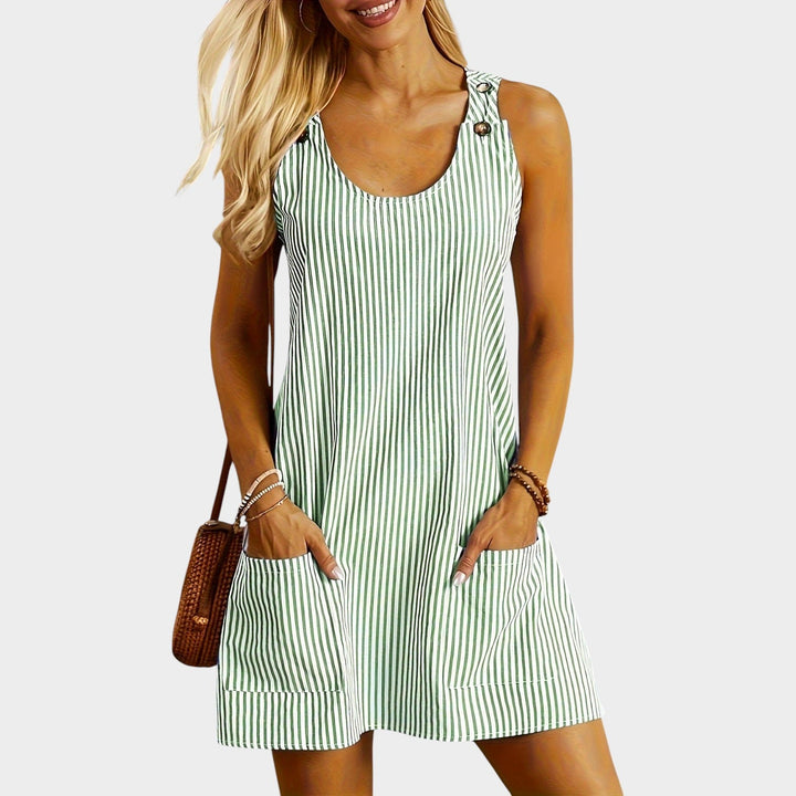 Woman wearing green striped sleeveless mini dress with pockets