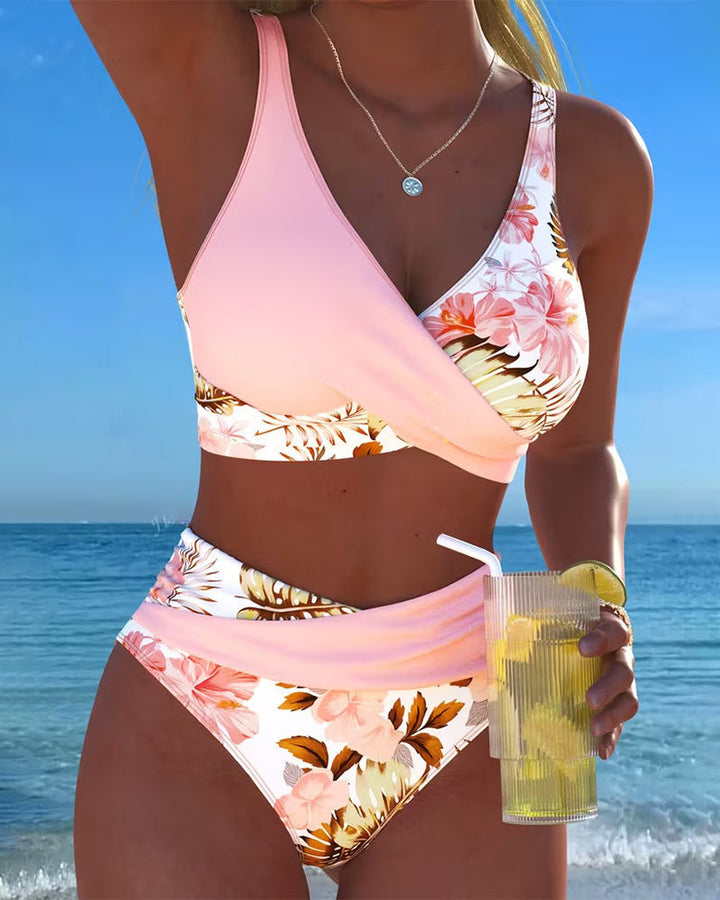 Women wearing pink tropical floral high waist bikini set by the ocean